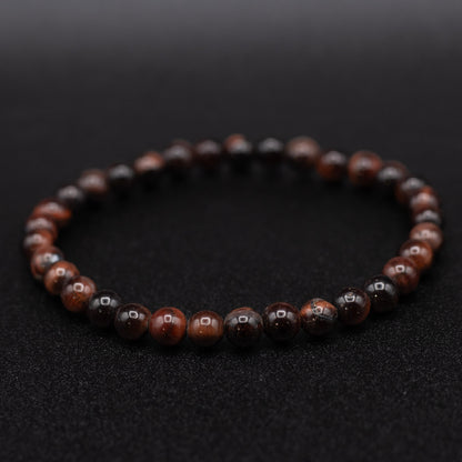 Beaded bracelet with brown and black beads on a dark background