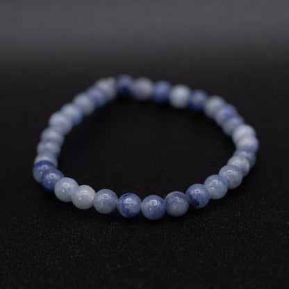 Beaded bracelet with blue and white stones on a black background