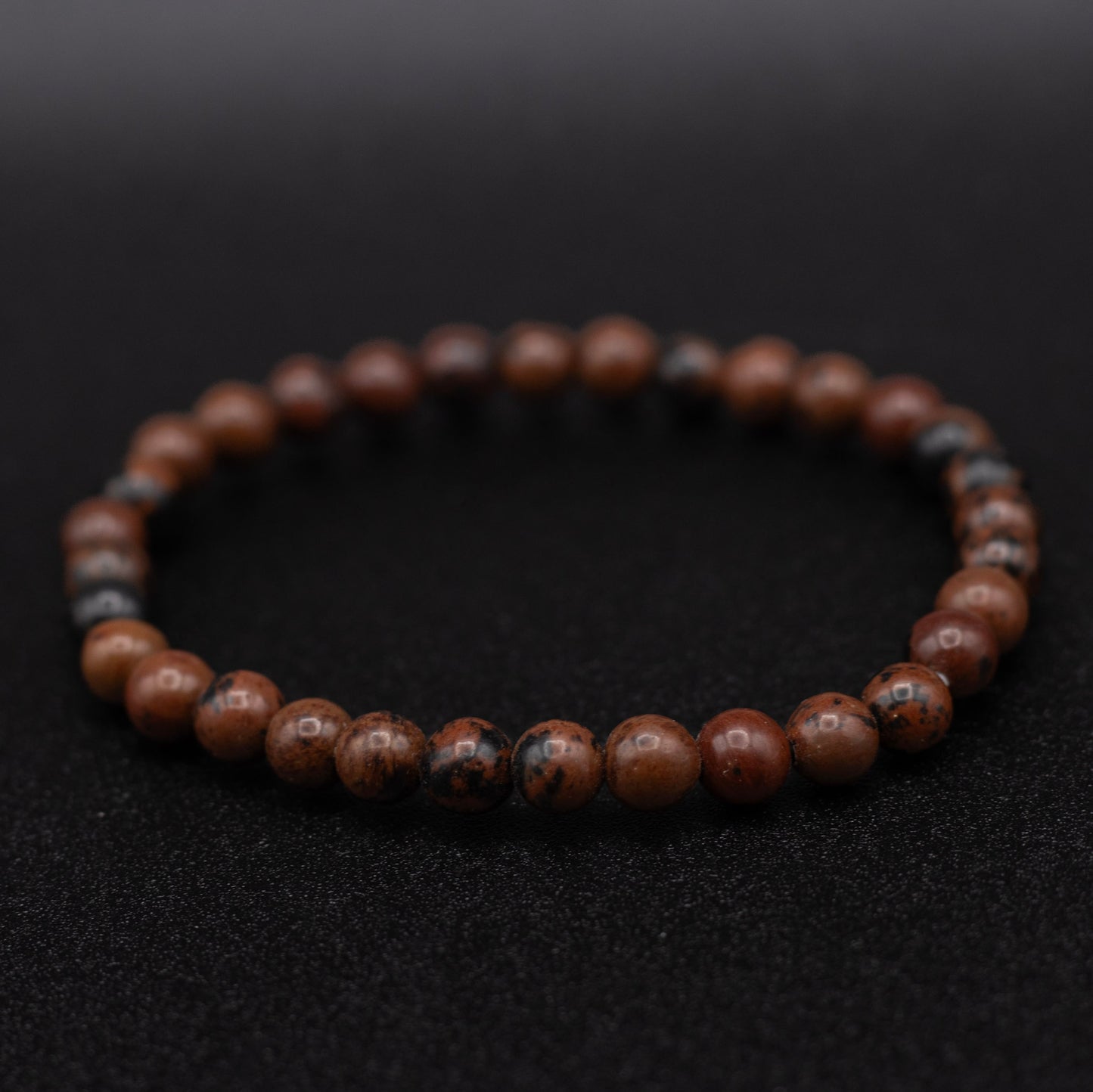 Brown beaded bracelet on a black background
