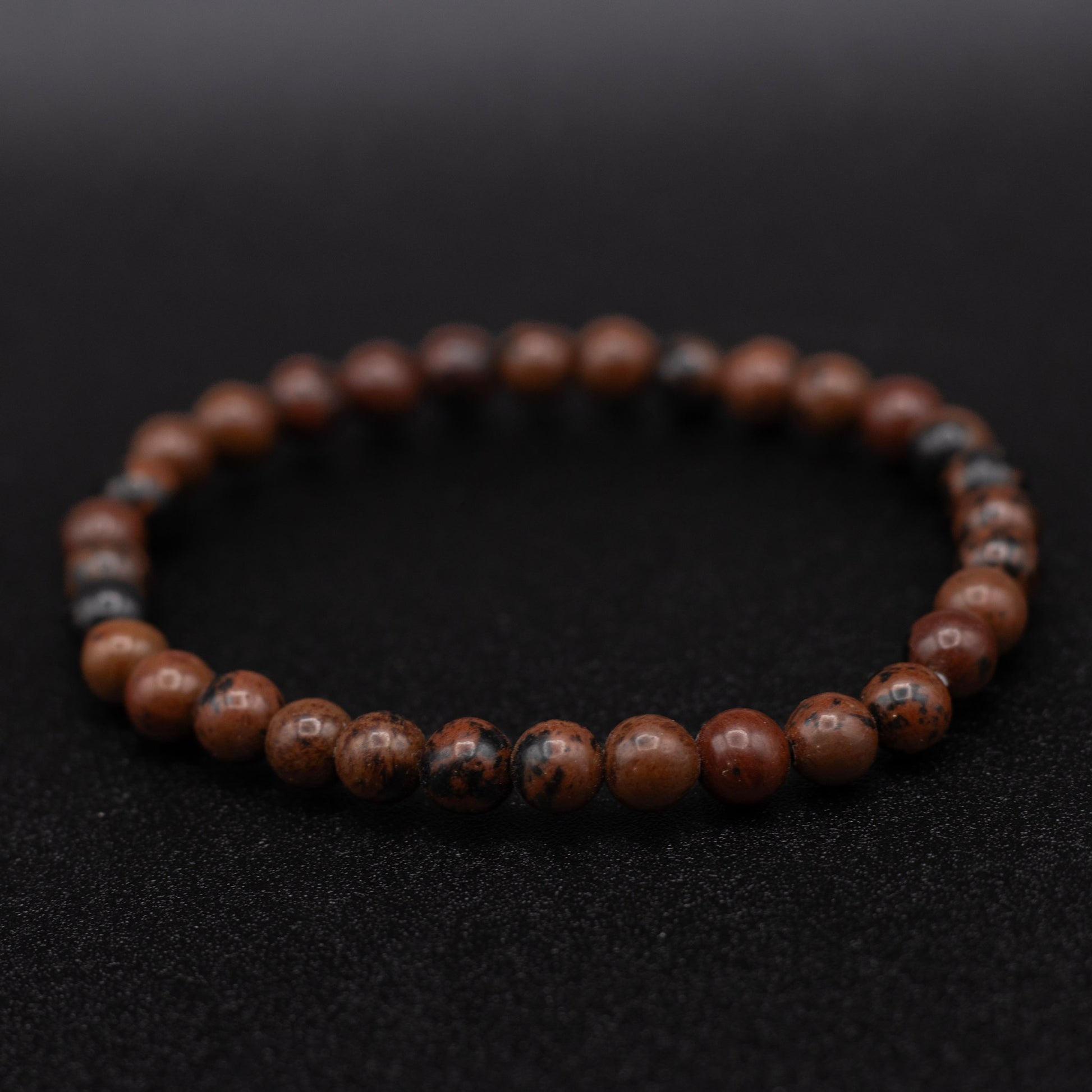 Brown beaded bracelet on a black background